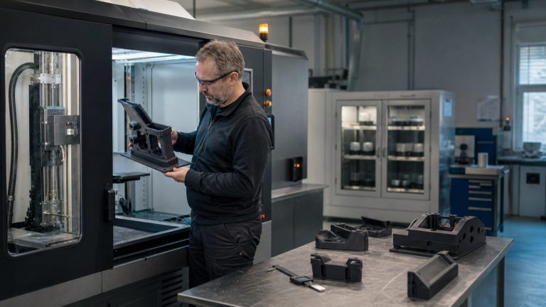 Additive manufacturing engineer inspecting a functional polymer component